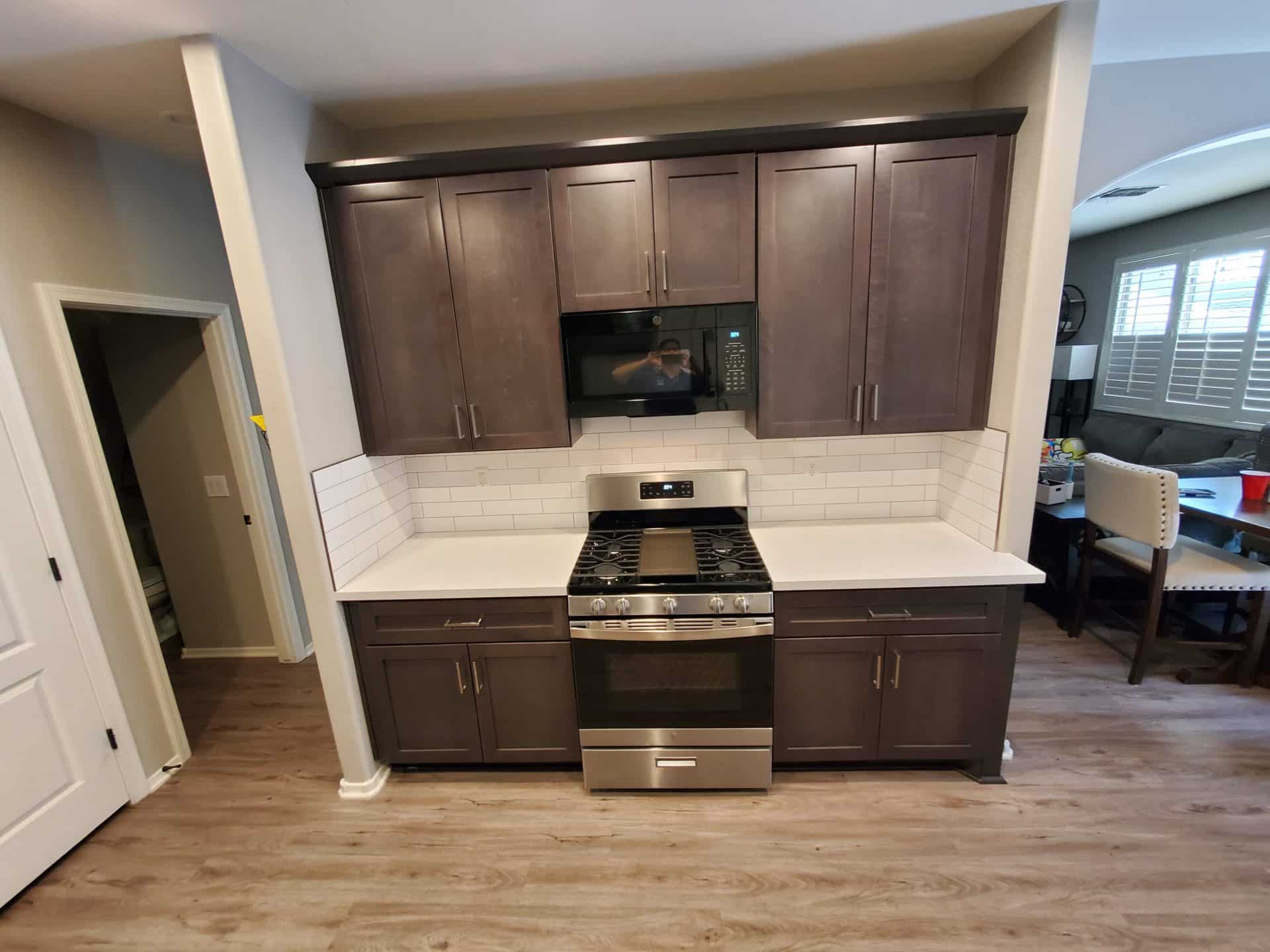 Espresso shaker cabinets, white quartz counters and a subway tile backsplash in an Ahwatukee kitchen