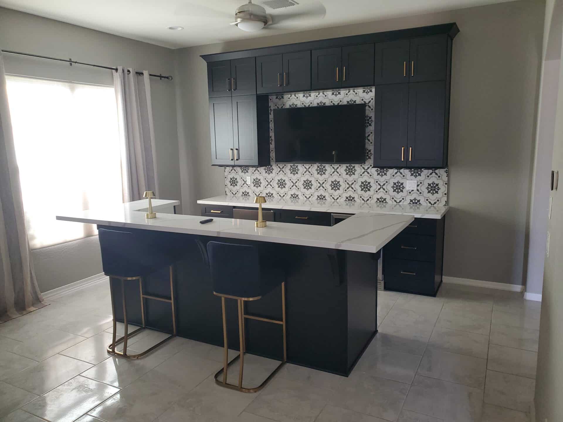 Navy dry bar with quartz counters and a patterned tile backsplash