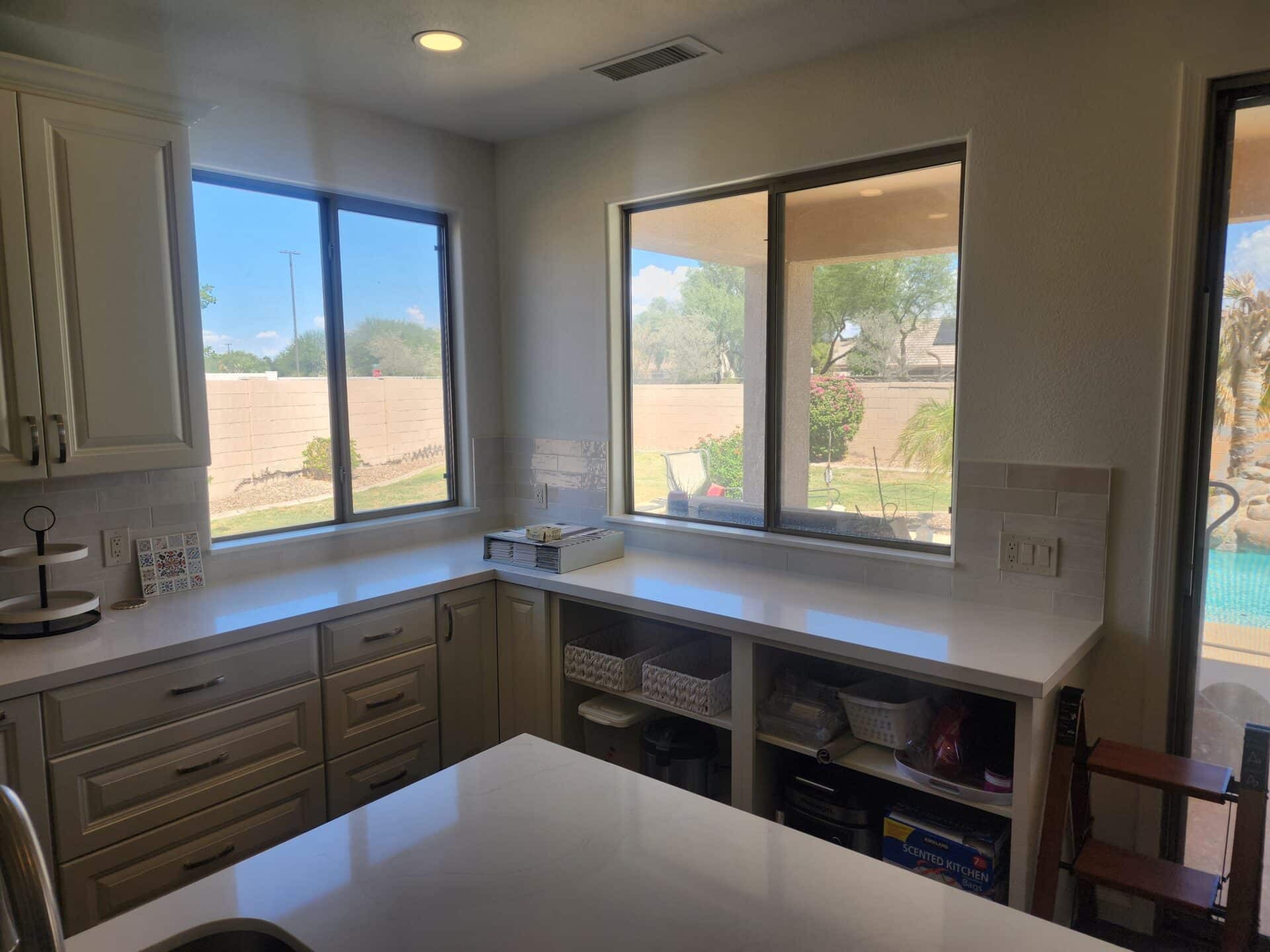 Quartz counters and tile backsplash in a completed Gilbert kitchen