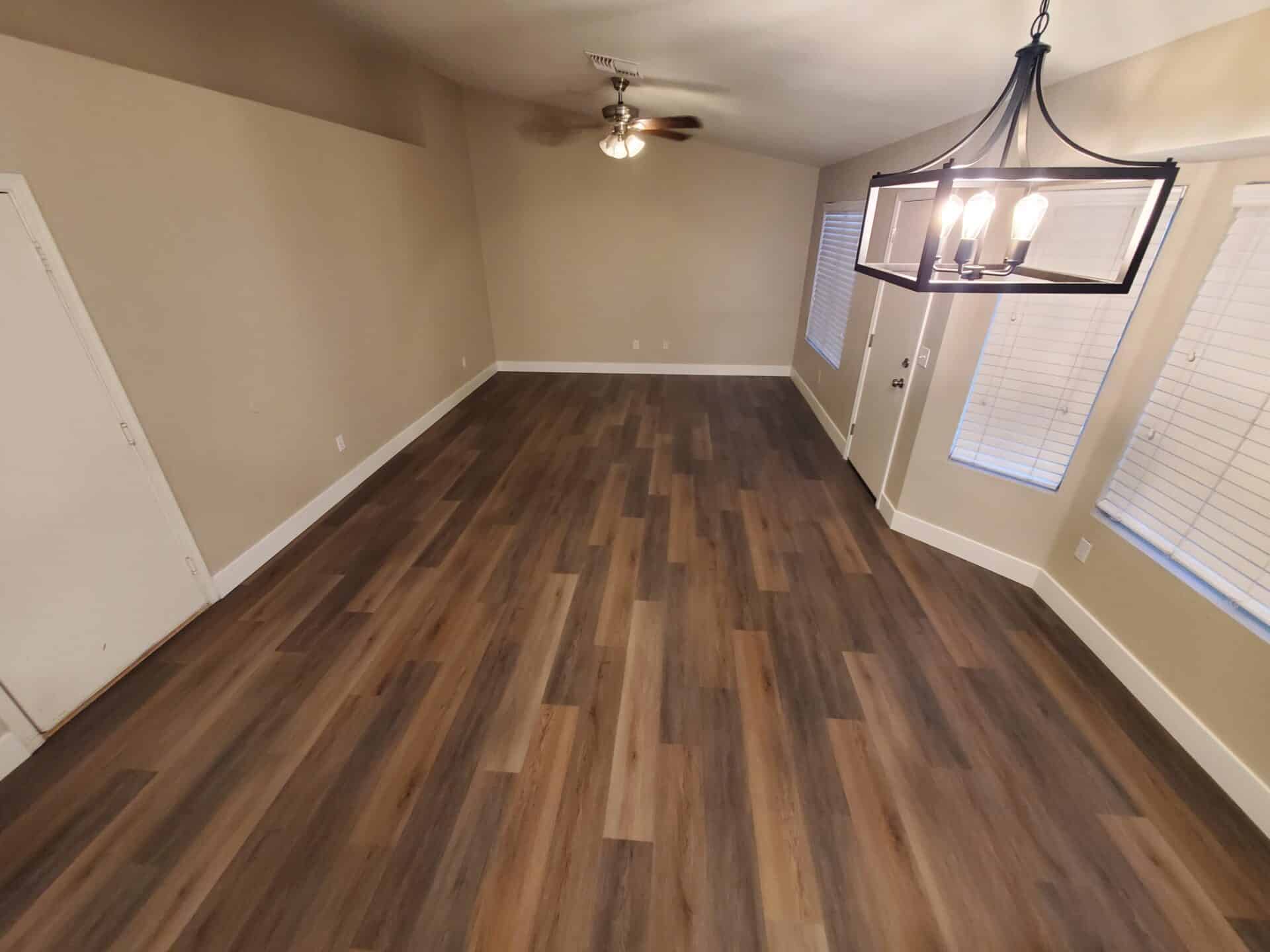 Wide-plank luxury vinyl flooring running through a completed East Valley living and dining room