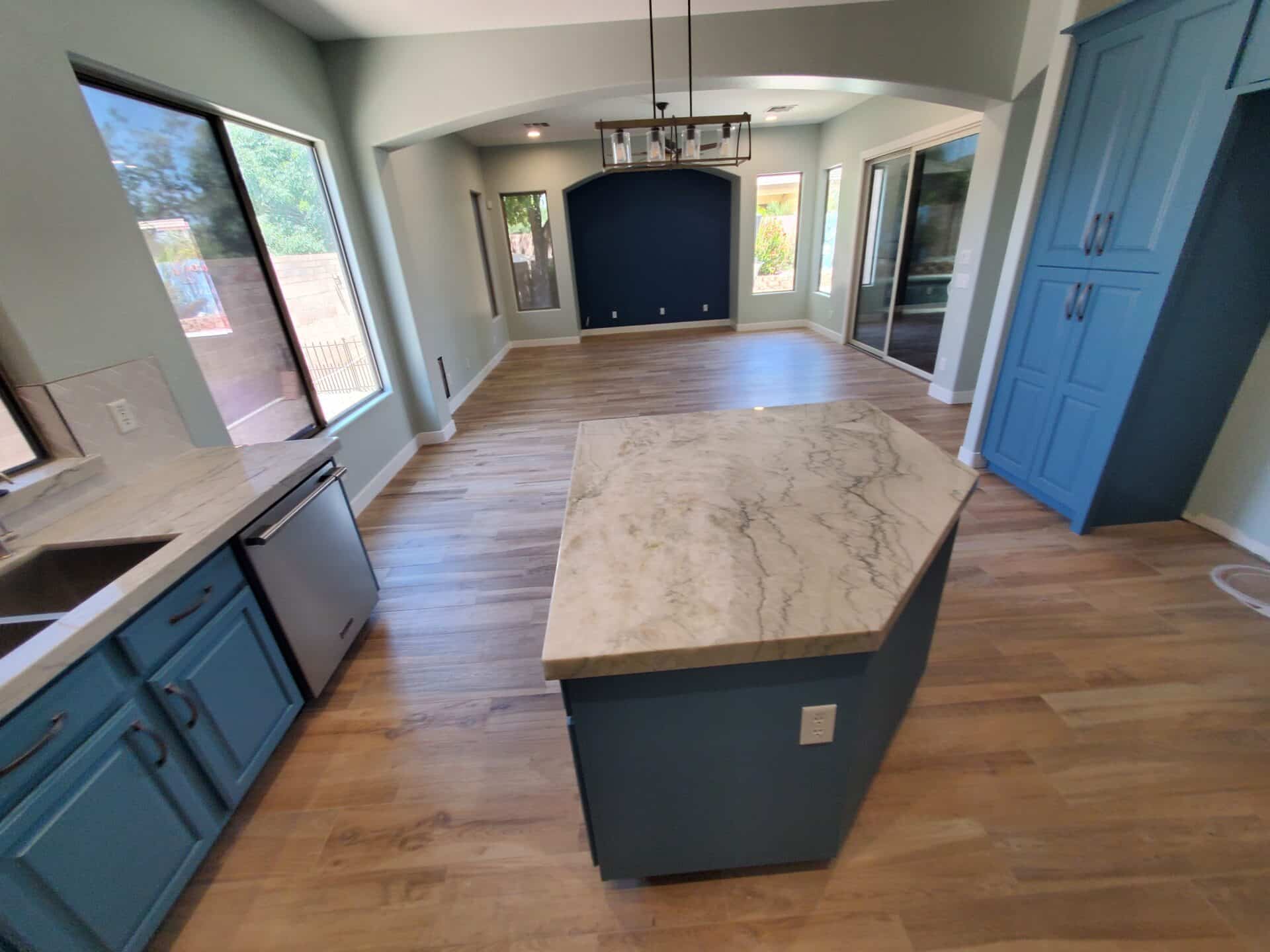 Blue painted cabinetry and a quartz island in a completed East Valley kitchen